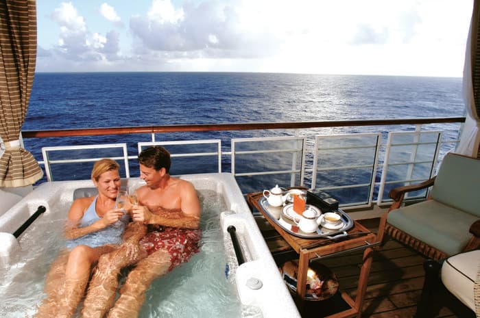 Disney Cruise Line Accommodation Couple Relaxing in whirlpool on private balcony.jpg
